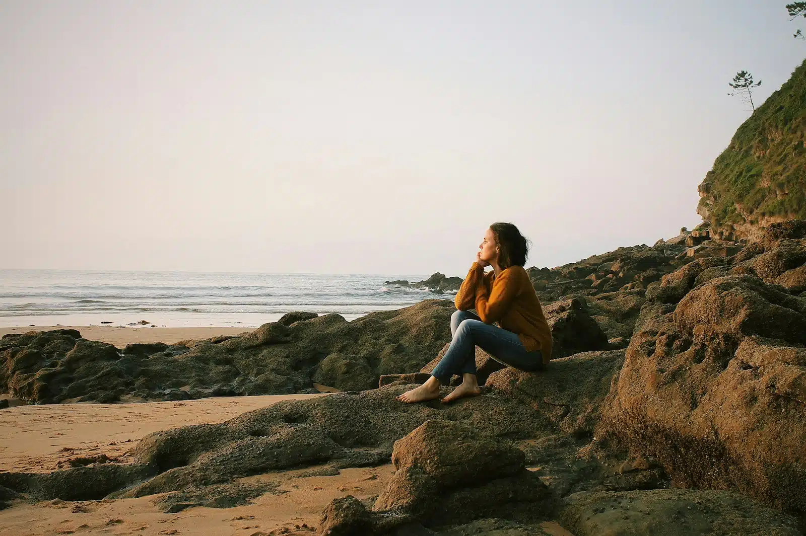 une femme assise en bord de mer